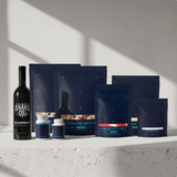 Collection of health and wellness products including a bottle and various packaging on a light background