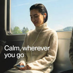 Woman on a train using white earbuds with the text Calm, wherever you go, Blueprint calm