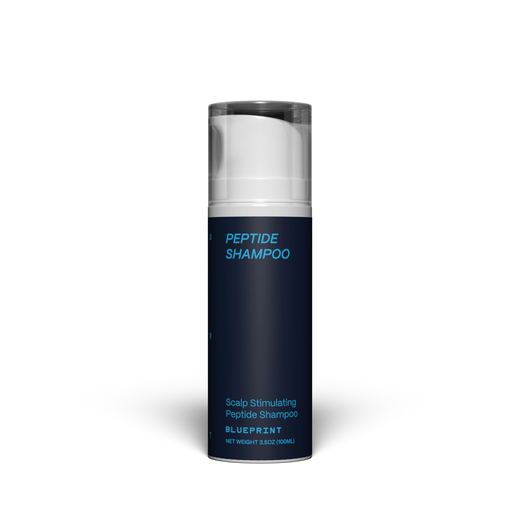 Blue shampoo bottle with white cap on a white background