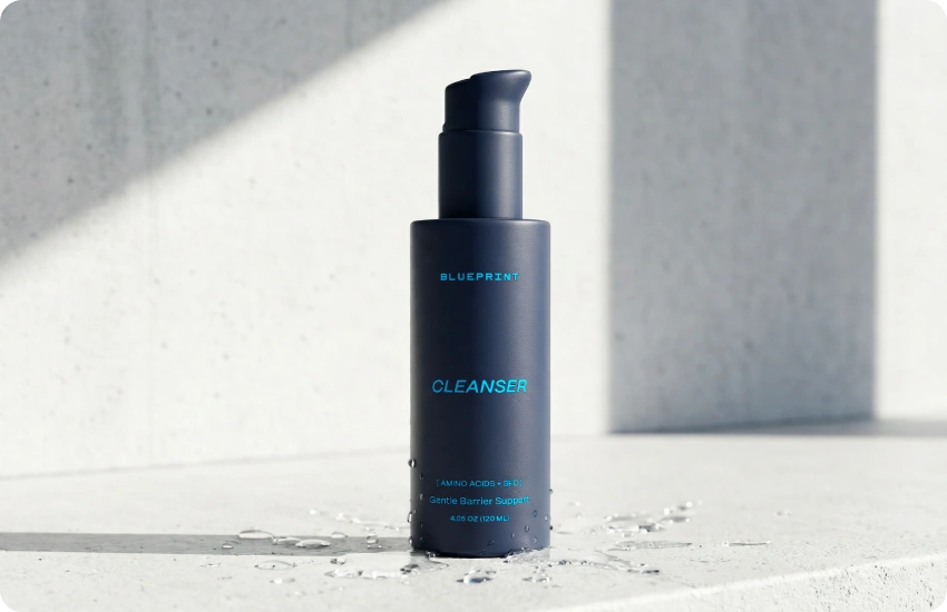 Blue bottle labeled 'Blueprint Cleanser' on a light gray background