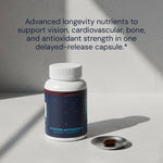 Bottle of 'Advanced Antioxidants' with a pill on a gray surface and text about nutrients.