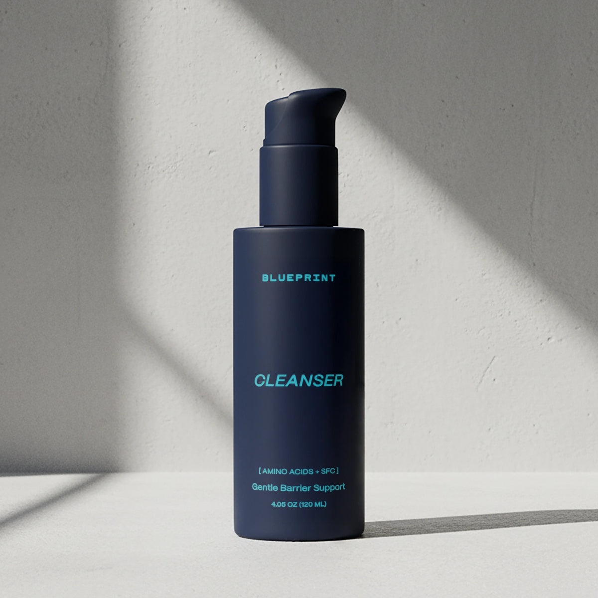 Blue bottle of Blueprint Cleanser on a light gray background