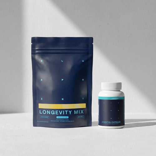Blue package labeled 'Longevity Mix' and a white bottle on a light gray background