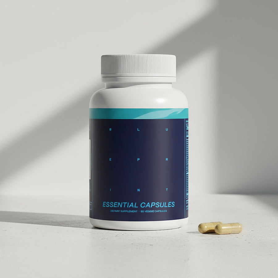 Supplement bottle labeled 'Essential Capsules' with a pill on a light surface