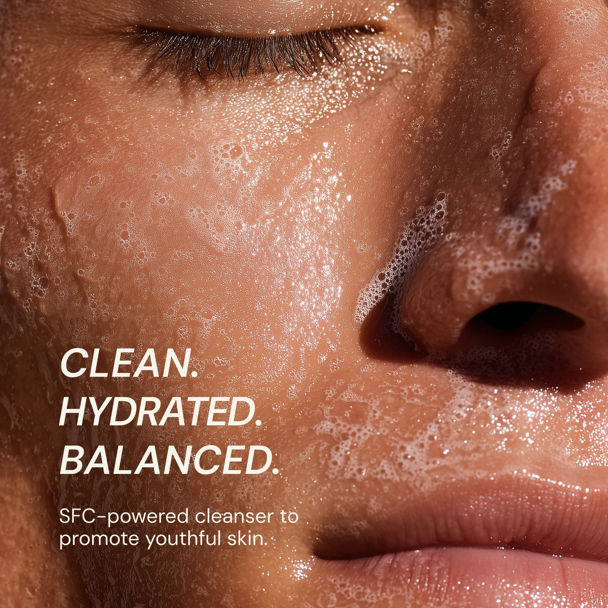 Close-up of a person's face with foamy cleanser on skin, text indicating product benefits.