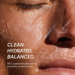 Close-up of a person's face with foamy cleanser on skin, text indicating product benefits.
