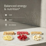 Snack bars with fruits on a concrete surface, promoting balanced energy and nutrition.