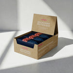 Box of Macadamia Protein Bars on a light gray background