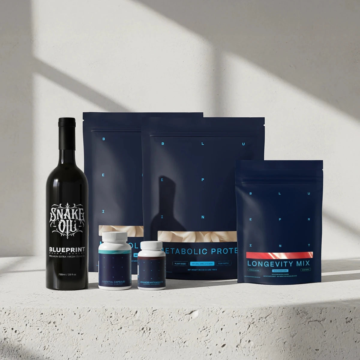 Collection of health and wellness products including a bottle and packages on a light surface with a neutral background.