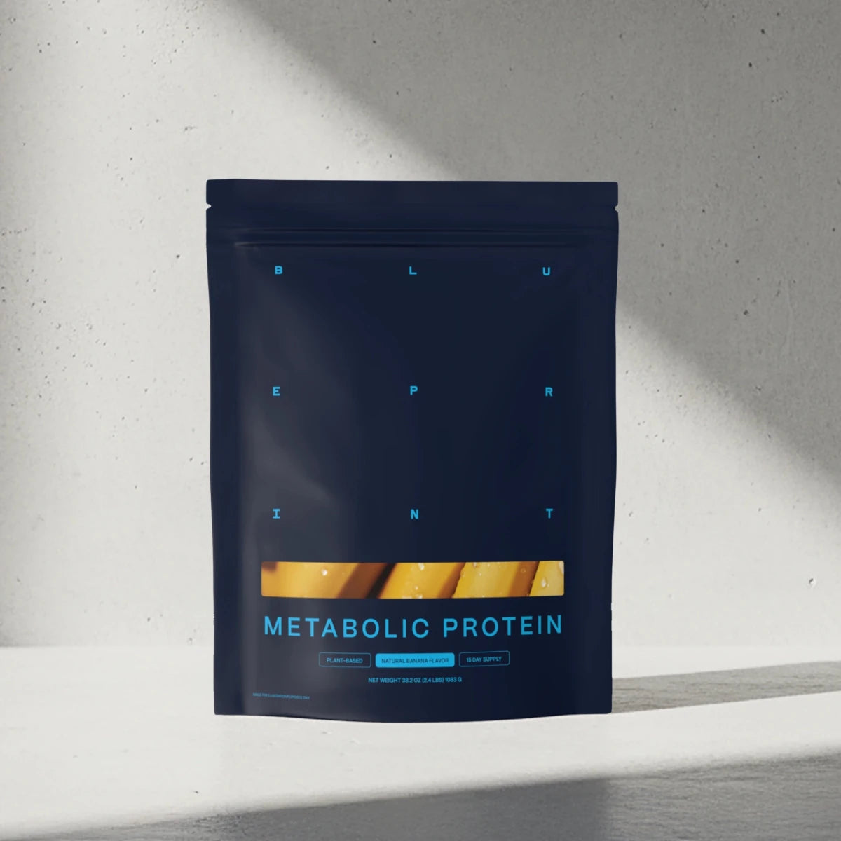 Dark blue package of Metabolic Protein on a light gray background 
