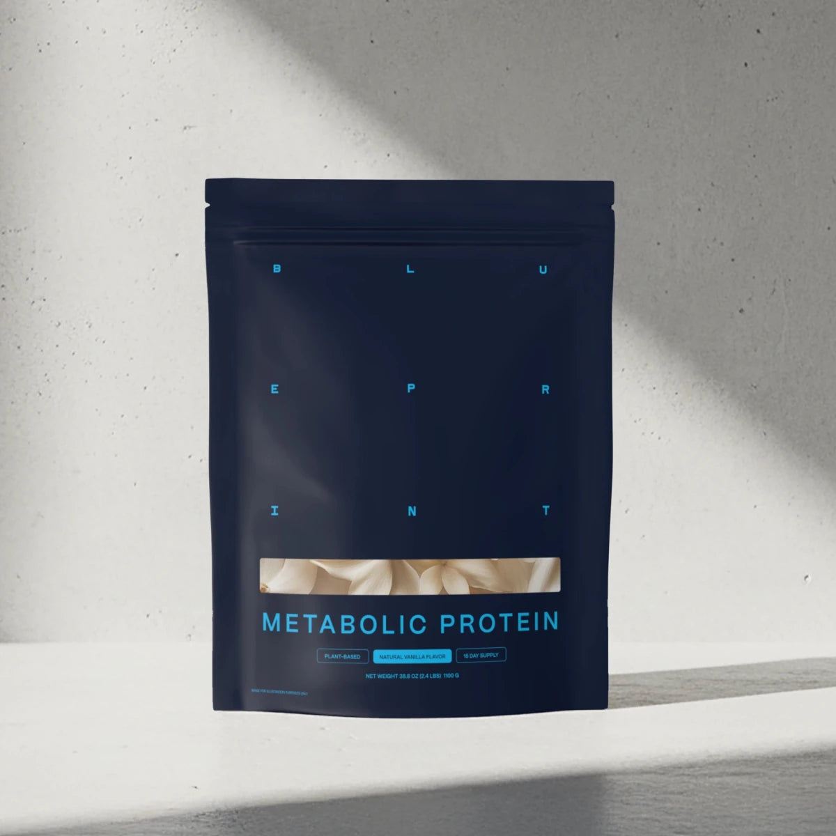 Dark blue package of Metabolic Protein on a light gray background #vanilla_15-day