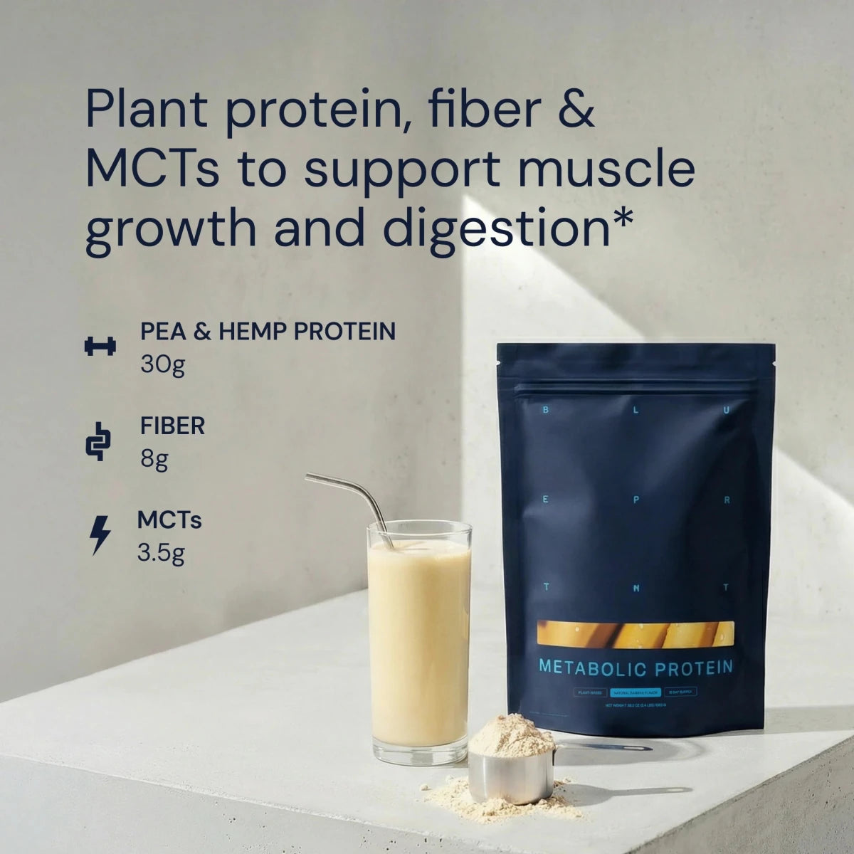 Metabolic Protein package with a glass of protein shake and scoop on a light surface.