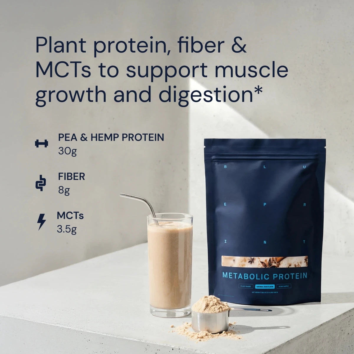 Metabolic Protein package with a glass of protein shake and scoop on a light surface.