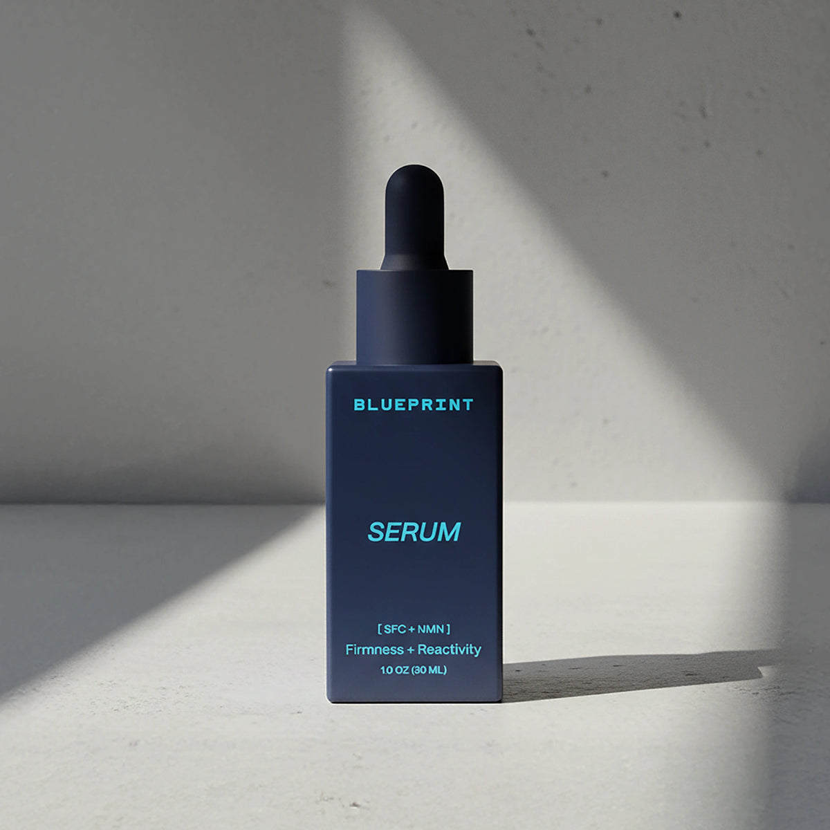 Blue serum bottle with dropper labeled 'Blueprint' on a light gray background