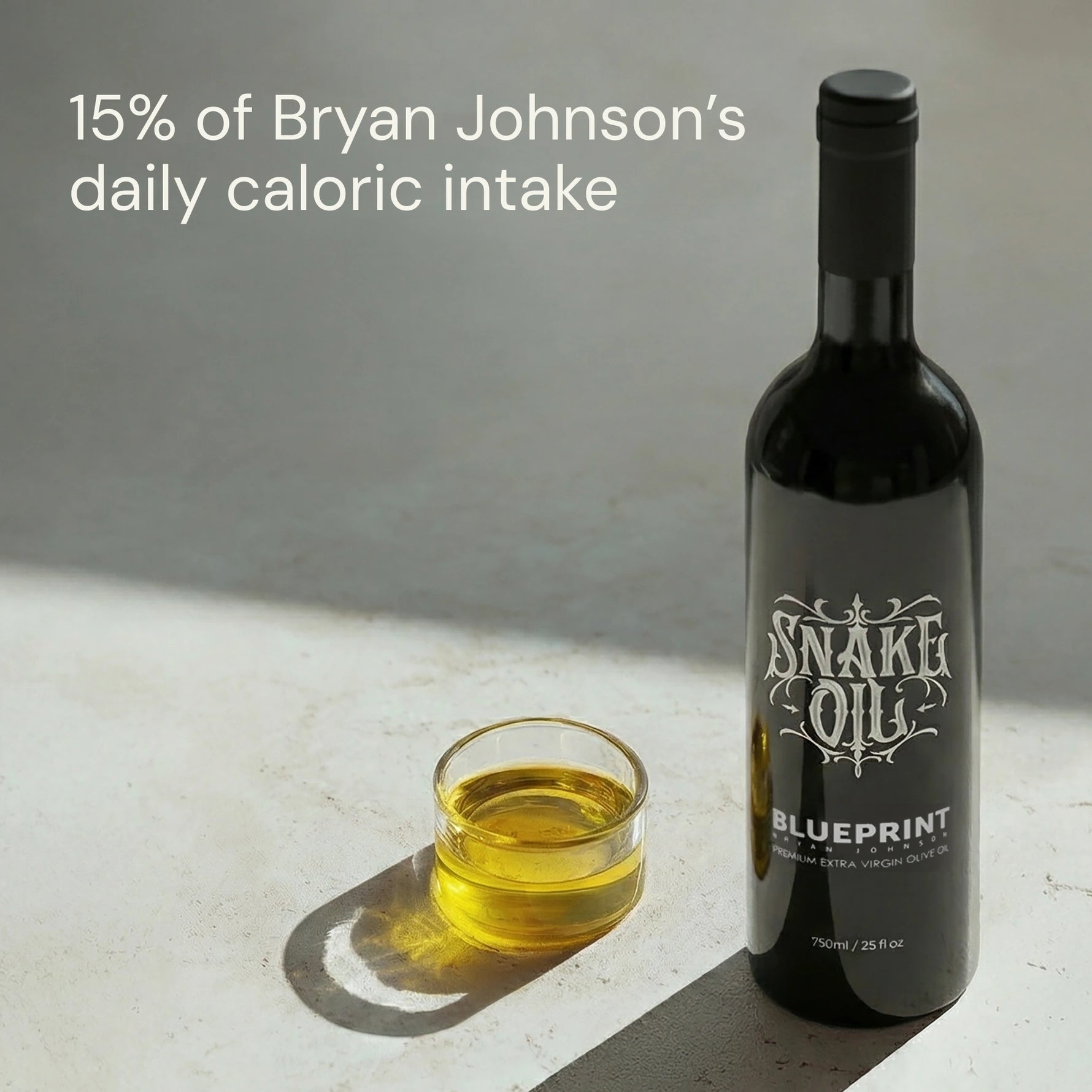 Bottle of 'Snake Oil Blueprint' with a glass of oil on a light surface.