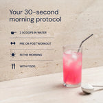 Pink drink with a straw in a glass on a light surface, with text about a 30-second morning protocol.