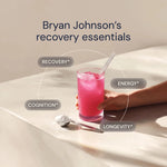 Glass of pink drink with a straw, surrounded by text on recovery, energy, cognition, and longevity, on a beige surface.