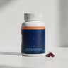 Blueprint Essential Microbiome supplement bottle with two magenta capsules on a white surface — longevity gut health