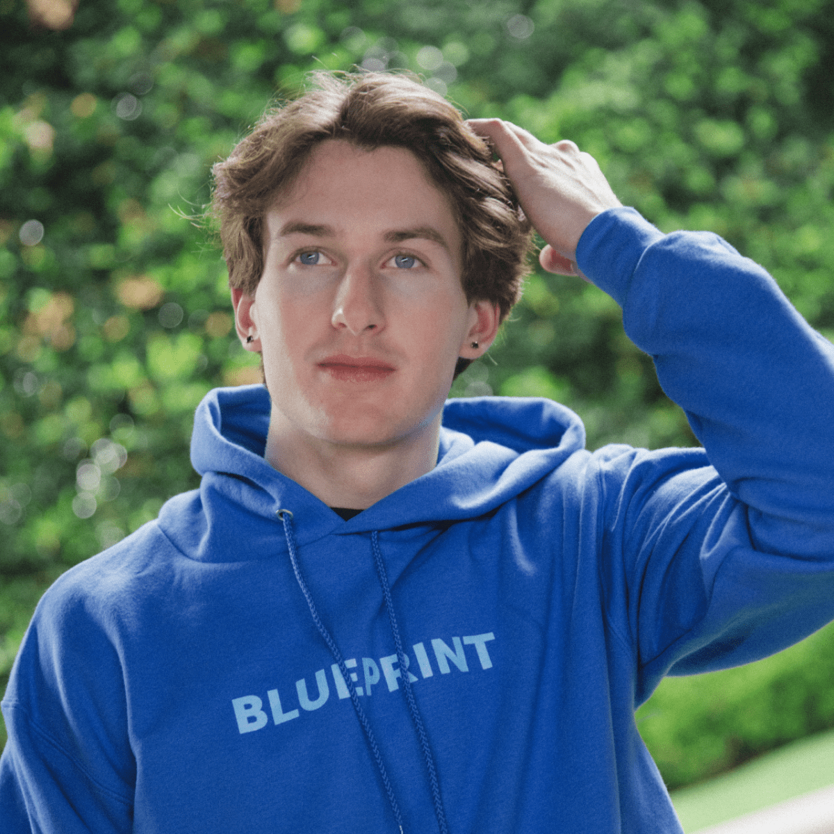Lifestyle image of boy wearing blue 'BLUEPRINT' Hoodie