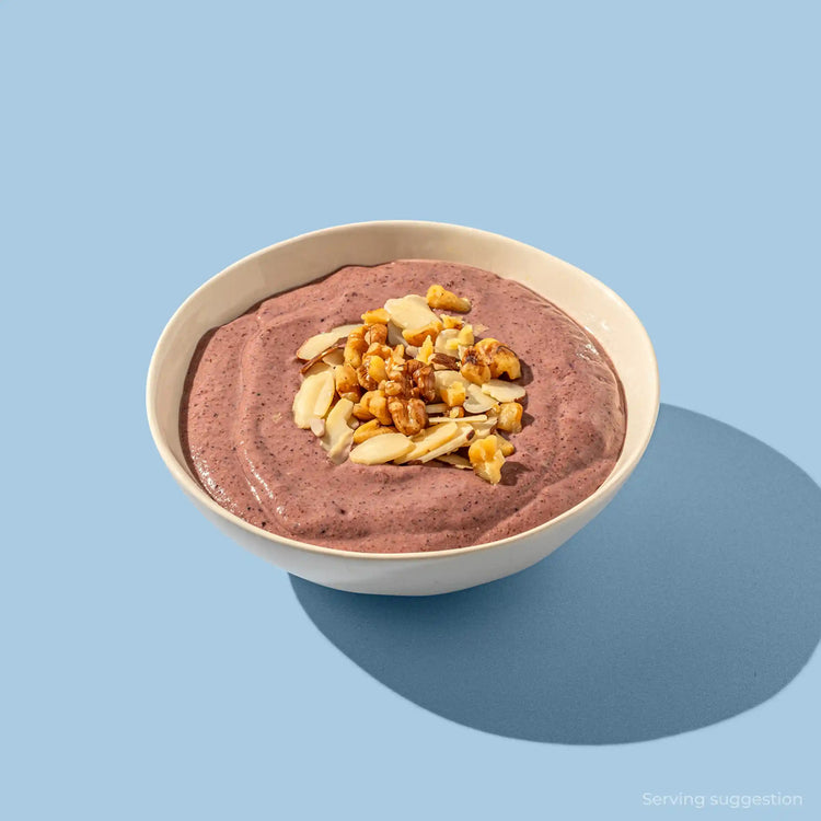 Blueprint longevity berry smoothie bowl topped with walnuts and sliced almonds, free from refined sugar