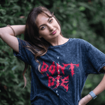 Lifestyle image of boy wearing 'Don't Die' grunge T-shirt 
