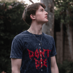 Lifestyle image of boy wearing 'Don't Die' grunge T-shirt 