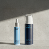 Peptide serum and shampoo bottles on a textured surface with a gray background