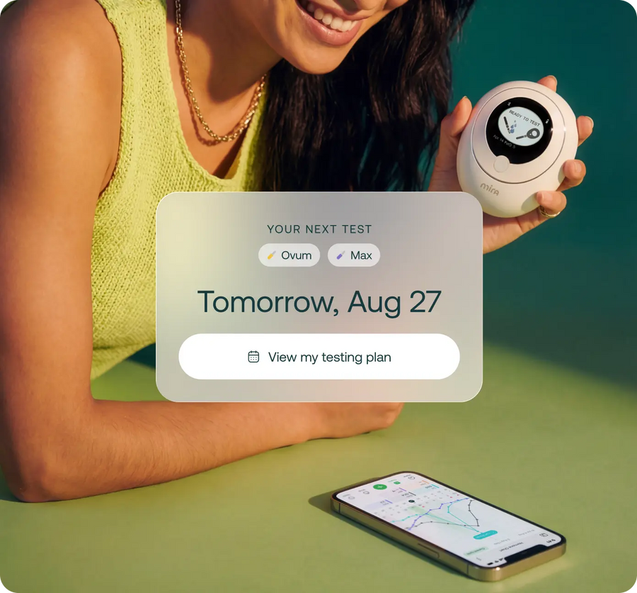 Woman using the Mira hormone monitor with an LH surge detected in the Mira app