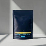 Blueprint Longevity Mix pouch on a sunlit white surface, a daily longevity drink mix