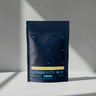 Blueprint Longevity Mix pouch on a sunlit white surface, a daily longevity drink mix