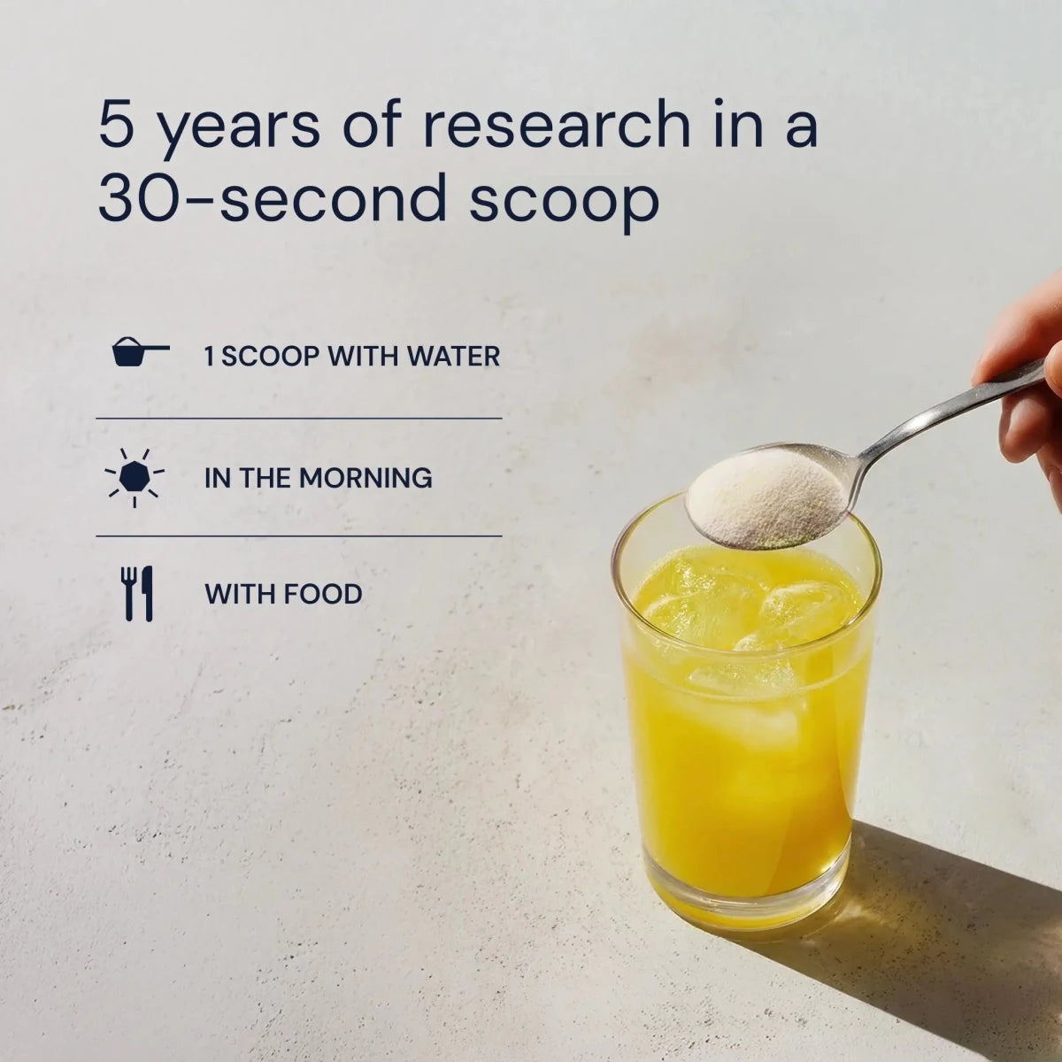 Scooping Blueprint Longevity Mix into a yellow citrus drink: 5 years of research in a 30-second scoop