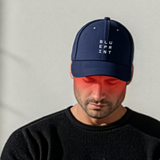 Person wearing a navy blue cap with 'BLUEPRINT' text on a plain background