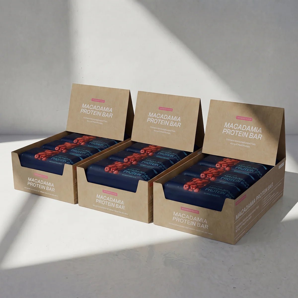 Three boxes of Blueprint Raspberry macadamia bars in a three-pack