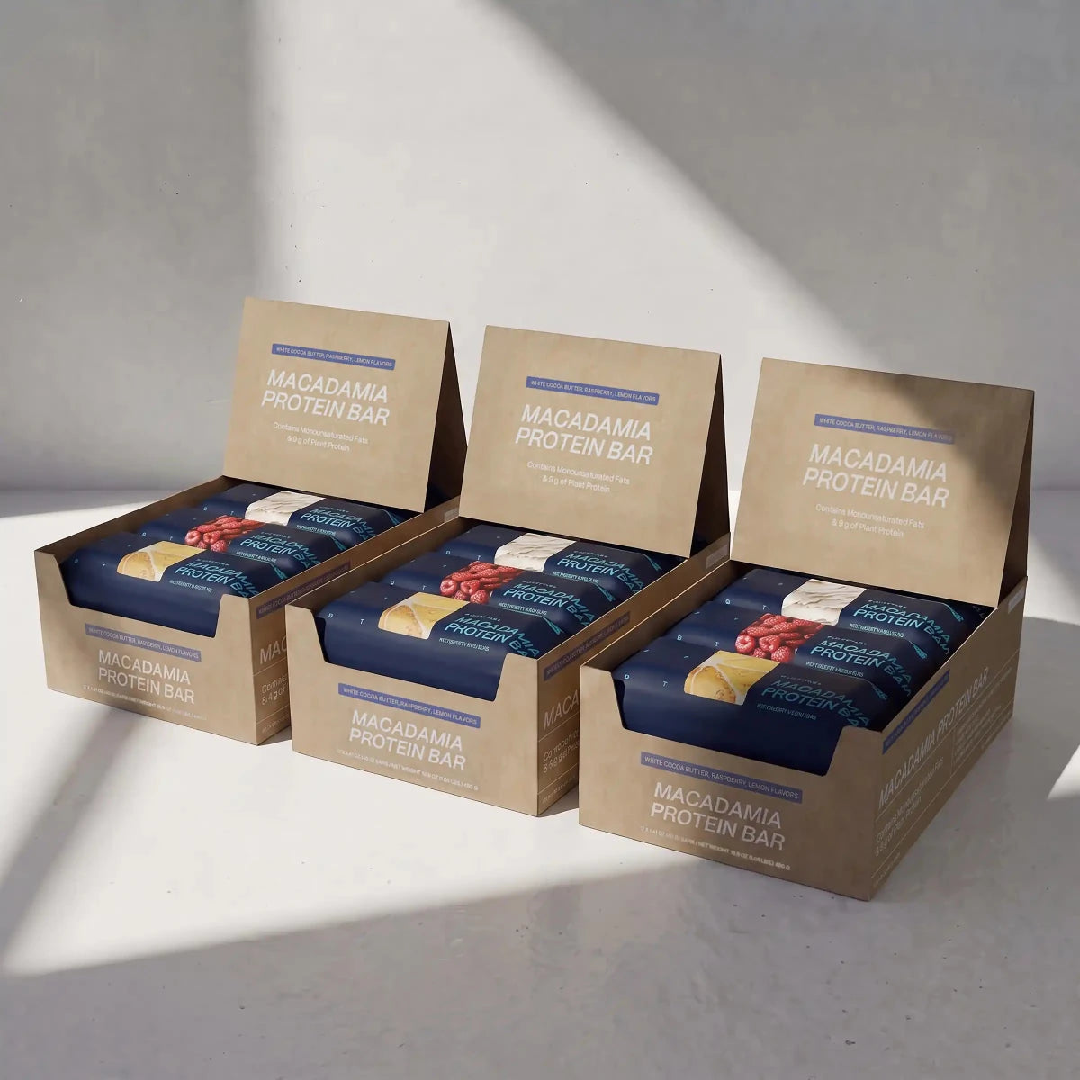 Three boxes of Blueprint macadamia bars in the variety three-pack