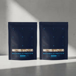 Two packages of Metabolic Protein on a gray surface with a light gray background 