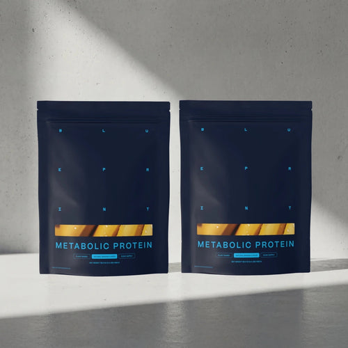 Two packages of Metabolic Protein on a gray surface with a light gray background #banana_30-day