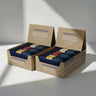 Two boxes of Macadamia Protein Bars on a light gray background