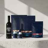 Collection of health and wellness products including a bottle and packages on a light surface with a neutral background.