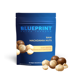 A package of Blueprint by Bryan Johnson Raw Macadamia Nuts, emphasizing heart-healthy monounsaturated fats. The package is blue with images of macadamia nuts in the foreground.