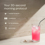 Glass of pink drink with a straw on a light surface, accompanied by text about a 30-second morning protocol.
