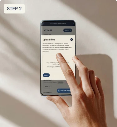 Hand holding a smartphone with an app interface on a light background