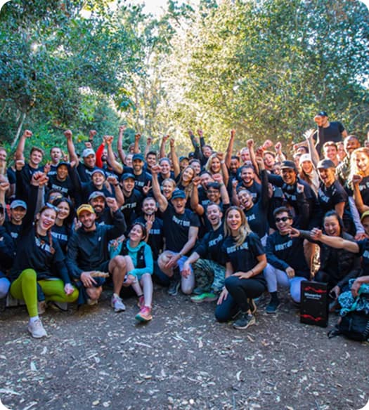 Group of Blueprint team posing together outdoors with trees in the background
