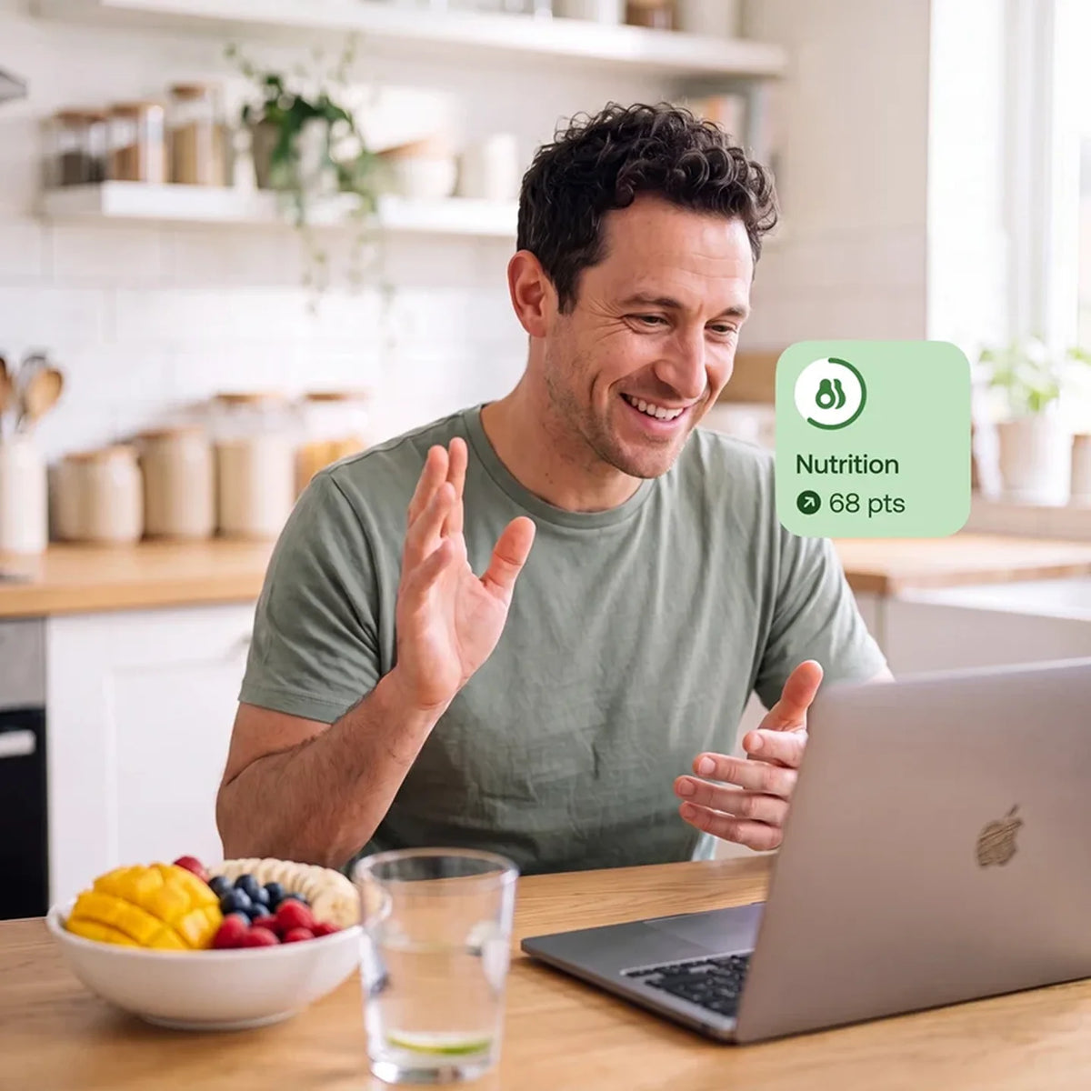Man in his kitchen on a video consultation reviewing personalized longevity nutrition guidance