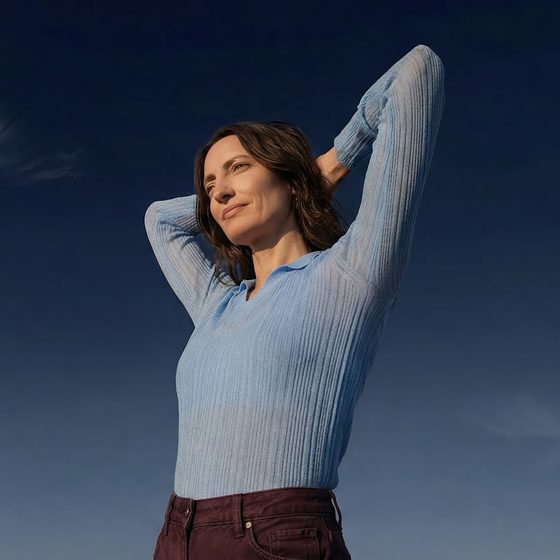 Woman in light blue sweater relaxing outdoors for Blueprint Rx email signup